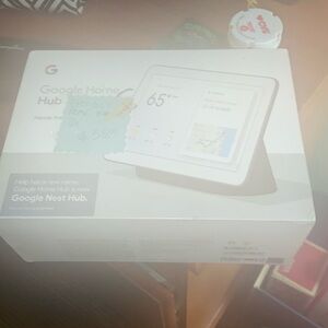 Still in the box with plastic google home hub NEW